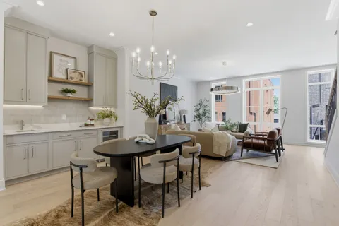 a view of a dining room with furniture and chandelier