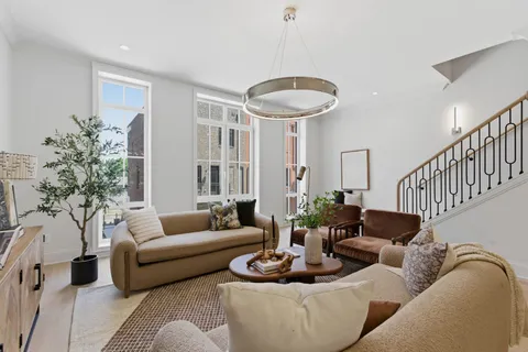 a living room with furniture and a chandelier