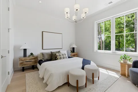 a bedroom with a bed and a chandelier