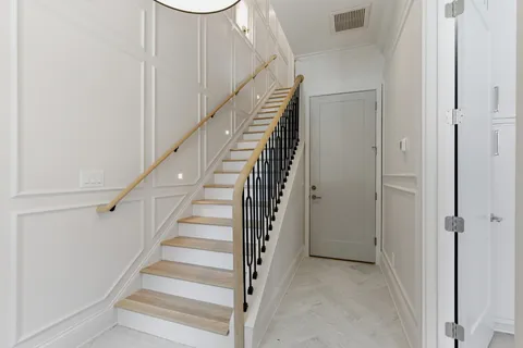 a view of entryway with wooden floor and stairs