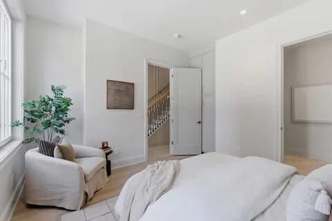 a bedroom with a bed and a couch