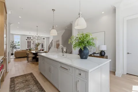 a kitchen with sink and living room view