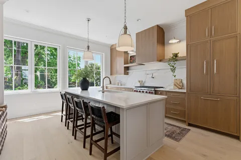 a kitchen with a table chairs and refrigerator