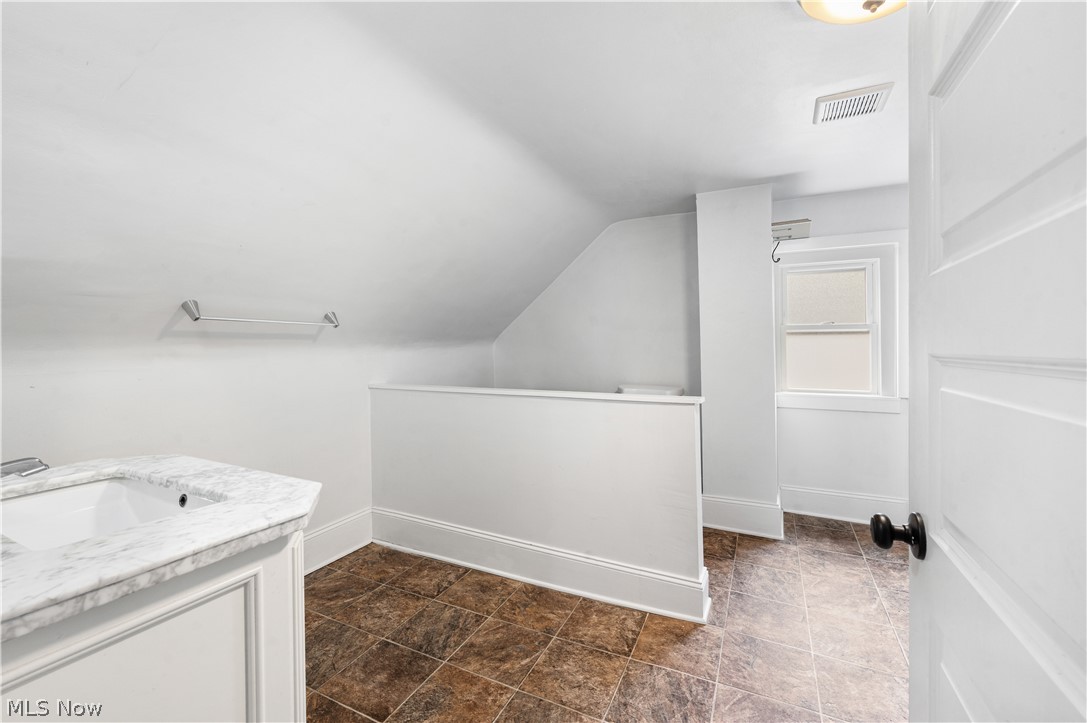 371 Merriman Road Akron, OH 44303 - Photo 20 of 27 White paneled vanity with a marble-look countertop and integral sink