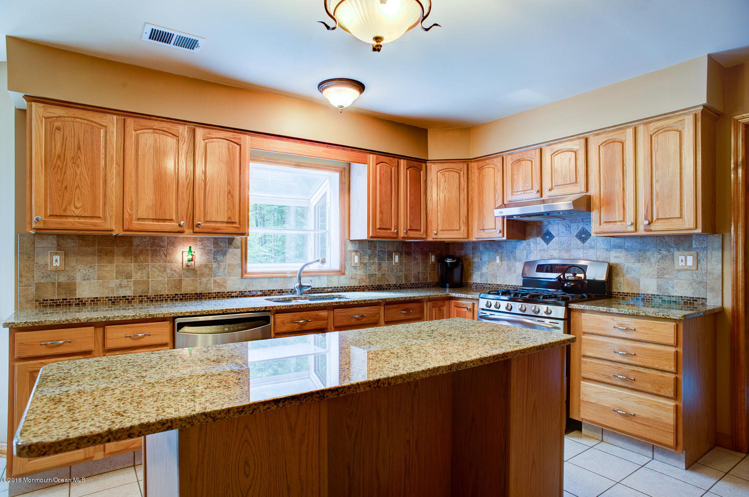 23 Rues Road Cream Ridge, NJ 08514 - Photo 12 of 45 a kitchen with stainless steel appliances granite countertop a sink stove and cabinets