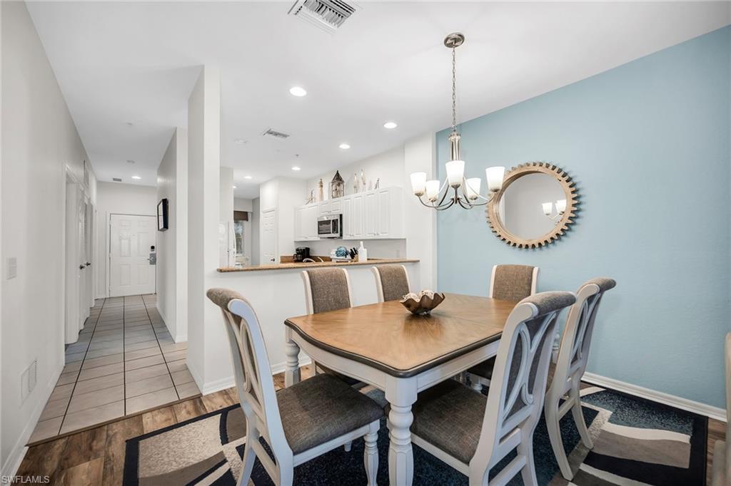 7930 Mahogany Run Lane, Unit 826 Naples, FL 34113 - Photo 12 of 50 a view of a dining room and chairs