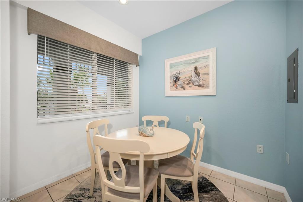 7930 Mahogany Run Lane, Unit 826 Naples, FL 34113 - Photo 13 of 50 a dining room with furniture and window