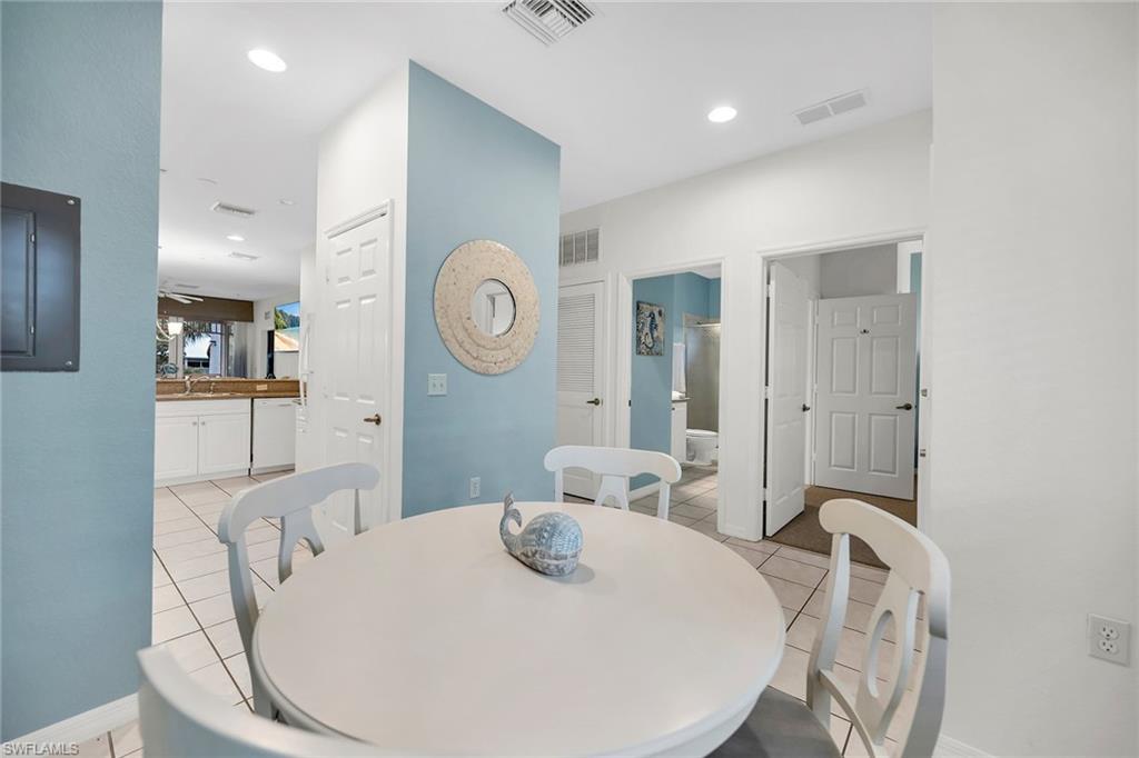 7930 Mahogany Run Lane, Unit 826 Naples, FL 34113 - Photo 14 of 50 a living room with furniture a mirror and white walls