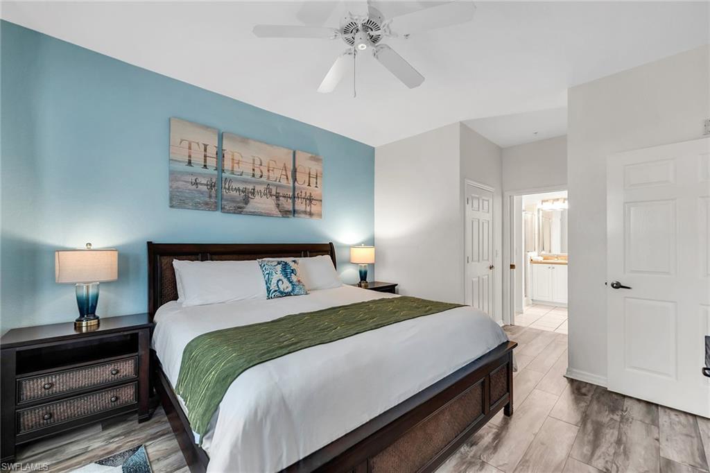 7930 Mahogany Run Lane, Unit 826 Naples, FL 34113 - Photo 15 of 50 a bedroom with a bed and a lamp