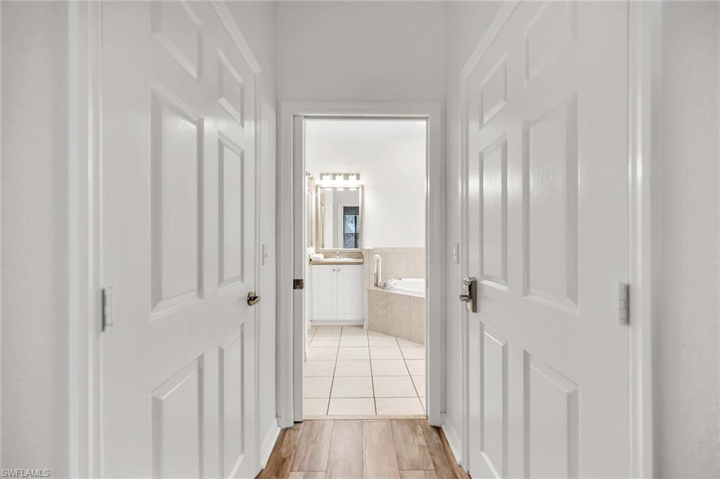7930 Mahogany Run Lane, Unit 826 Naples, FL 34113 - Photo 17 of 50 a view of a bathroom from a hallway