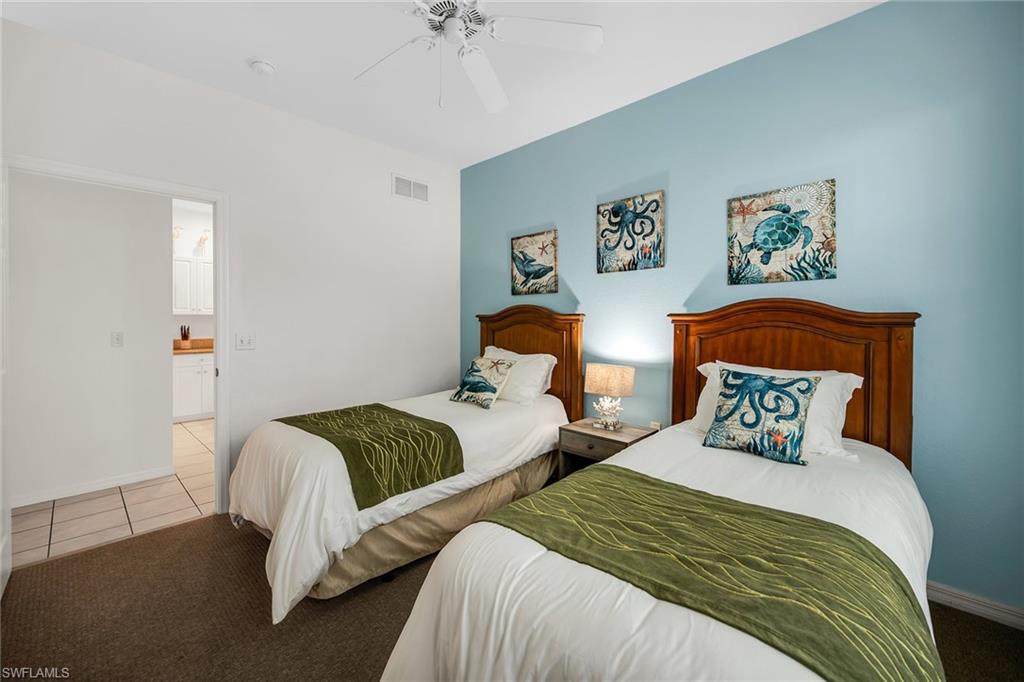 7930 Mahogany Run Lane, Unit 826 Naples, FL 34113 - Photo 20 of 50 a bedroom with two beds and painting on the wall