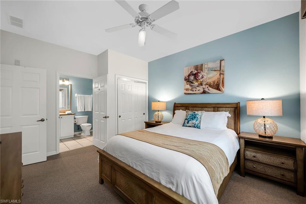 7930 Mahogany Run Lane, Unit 826 Naples, FL 34113 - Photo 23 of 50 a bedroom with bed and a chandelier