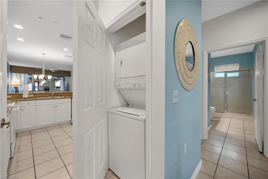 7930 Mahogany Run Lane, Unit 826 Naples, FL 34113 - Photo 25 of 50 a bathroom with a toilet a sink and a mirror