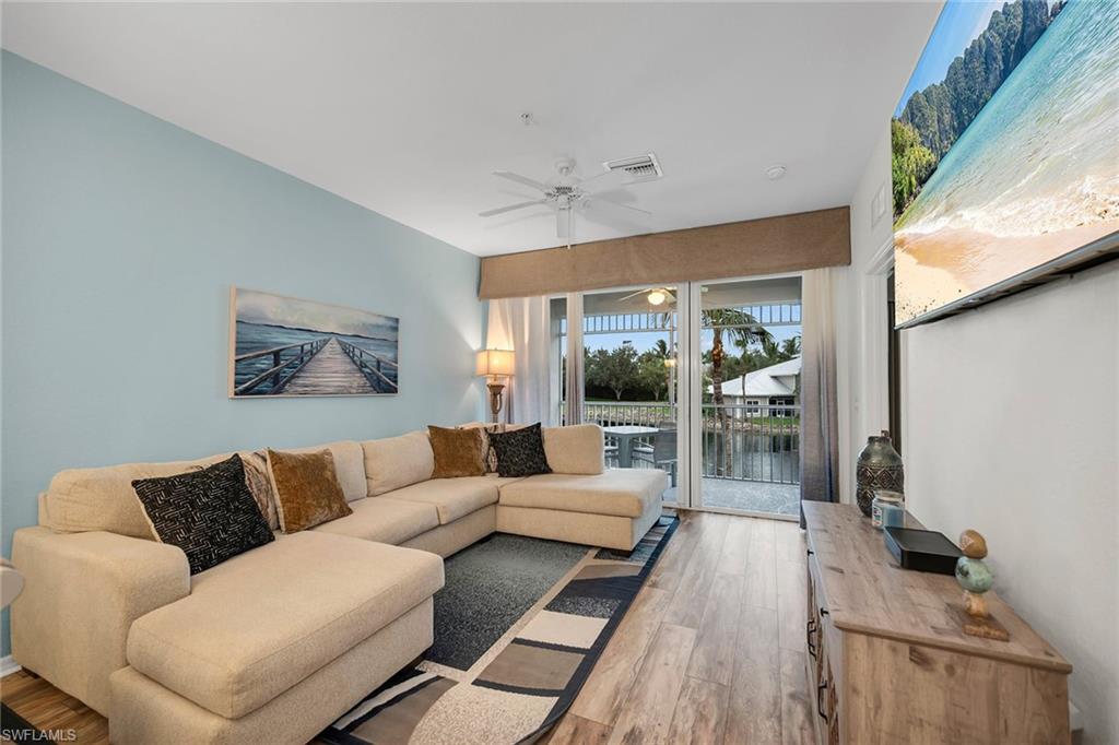 7930 Mahogany Run Lane, Unit 826 Naples, FL 34113 - Photo 3 of 50 a living room with furniture and a large window