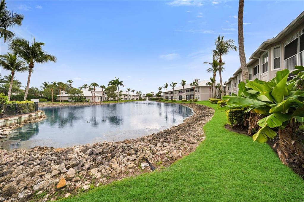 7930 Mahogany Run Lane, Unit 826 Naples, FL 34113 - Photo 32 of 50 a view of a lake with a yard