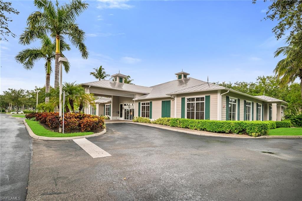 7930 Mahogany Run Lane, Unit 826 Naples, FL 34113 - Photo 33 of 50 a front view of a house with a garden and yard