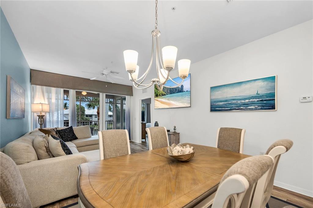 7930 Mahogany Run Lane, Unit 826 Naples, FL 34113 - Photo 49 of 50 a living room with furniture a window and dining table