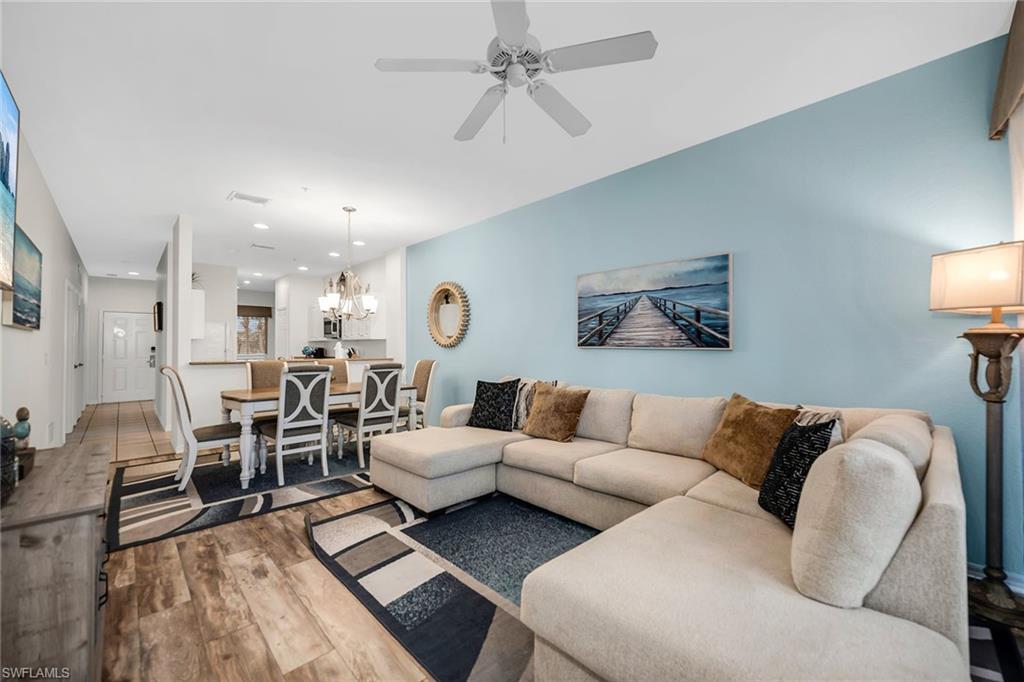 7930 Mahogany Run Lane, Unit 826 Naples, FL 34113 - Photo 5 of 50 a living room with furniture and a large window
