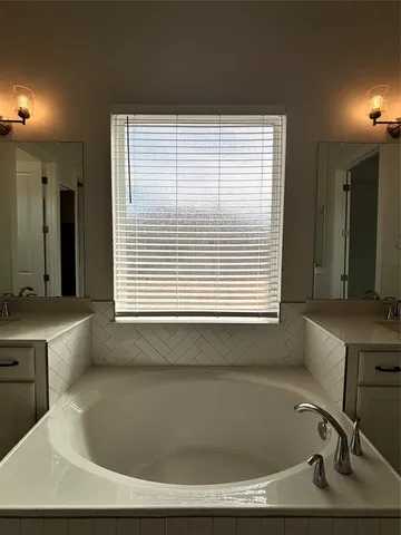 a bathroom with a bathtub and a sink