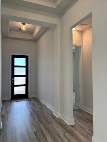 an empty room with wooden floor and closet