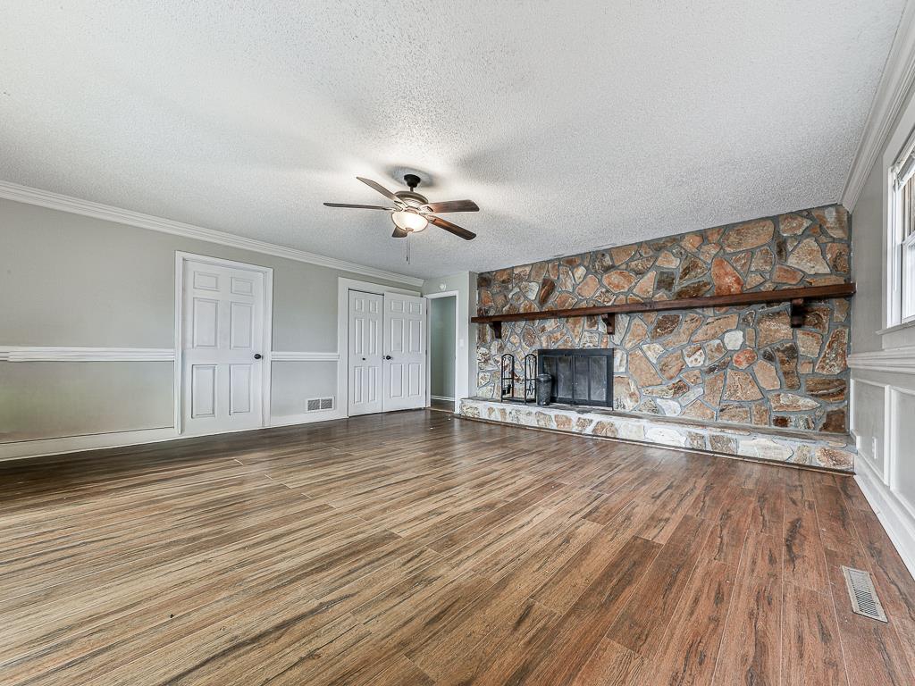 617 Crippled Oak Trail Jasper, GA 30143 - Photo 12 of 45 a view of empty room with wooden floor and fireplace