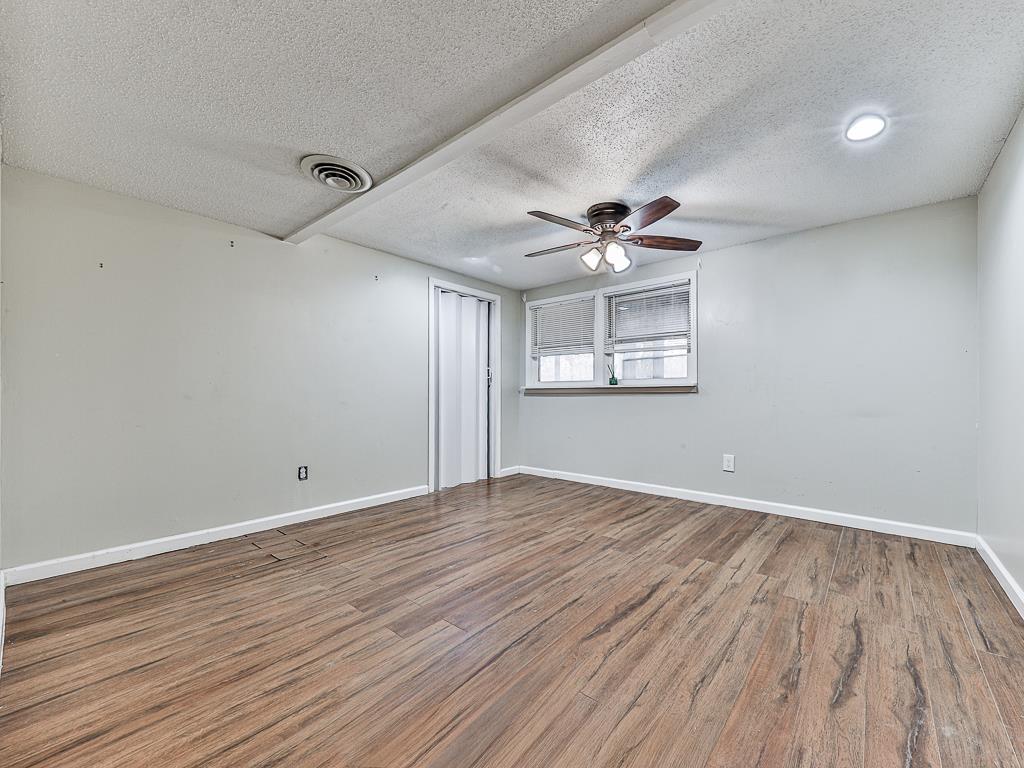 617 Crippled Oak Trail Jasper, GA 30143 - Photo 8 of 45 a view of an empty room with a window and wooden floor