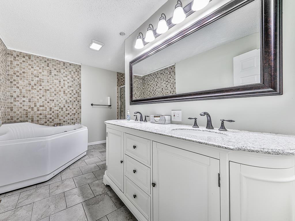 617 Crippled Oak Trail Jasper, GA 30143 - Photo 10 of 45 a bathroom with a granite countertop sink mirror and bathtub