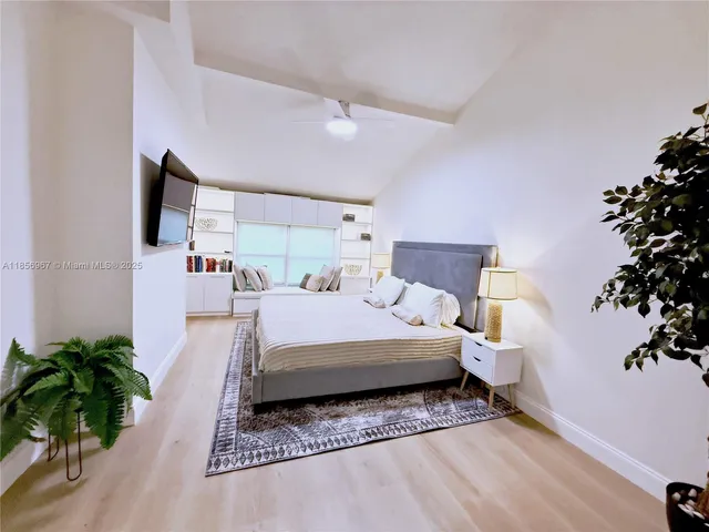 a bed room with a bed and a potted plant