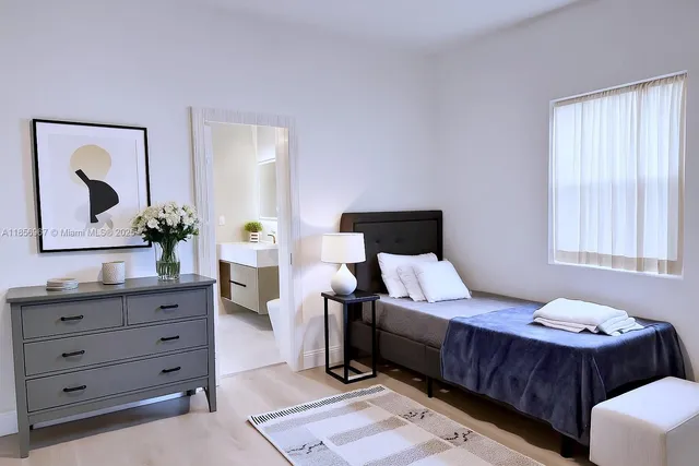 a bedroom with a bed and a dresser