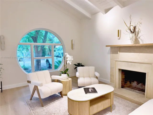a living room with furniture a window and a fireplace