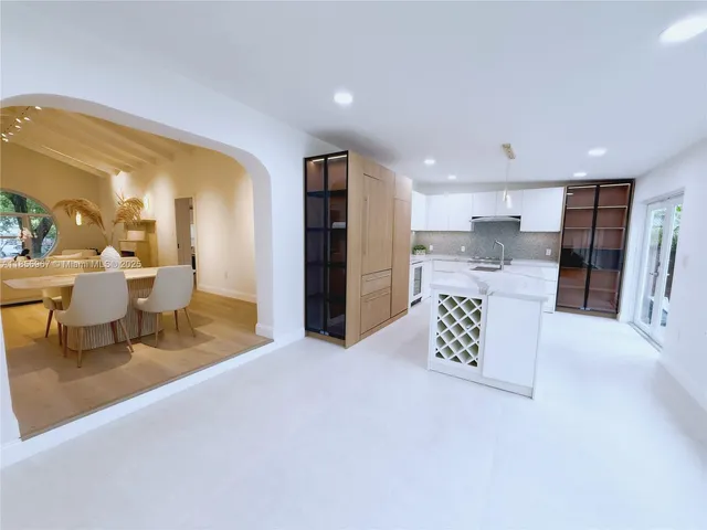 a living room with a couch and kitchen view