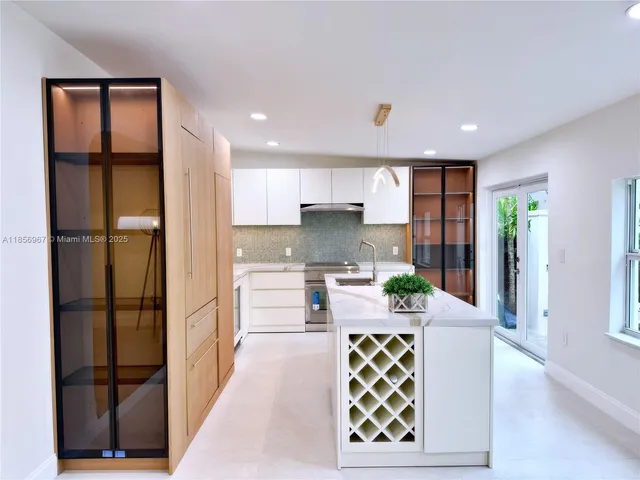 a kitchen with stainless steel appliances granite countertop a refrigerator and a stove top oven