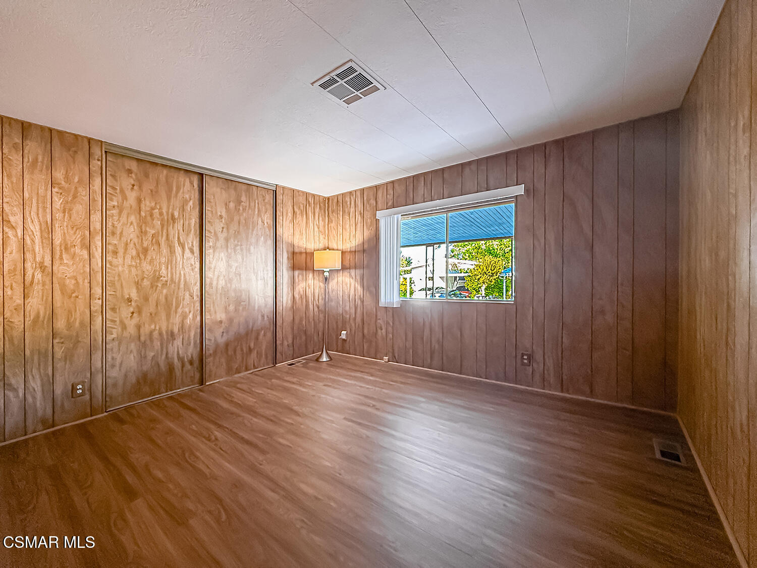 6480 Katherine Street, Unit 109 Simi Valley, CA 93063 - Photo 13 of 29 an empty room with wooden floor and windows