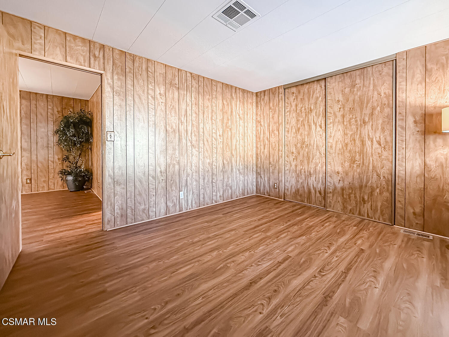 6480 Katherine Street, Unit 109 Simi Valley, CA 93063 - Photo 14 of 29 an empty room with wooden floor and a window