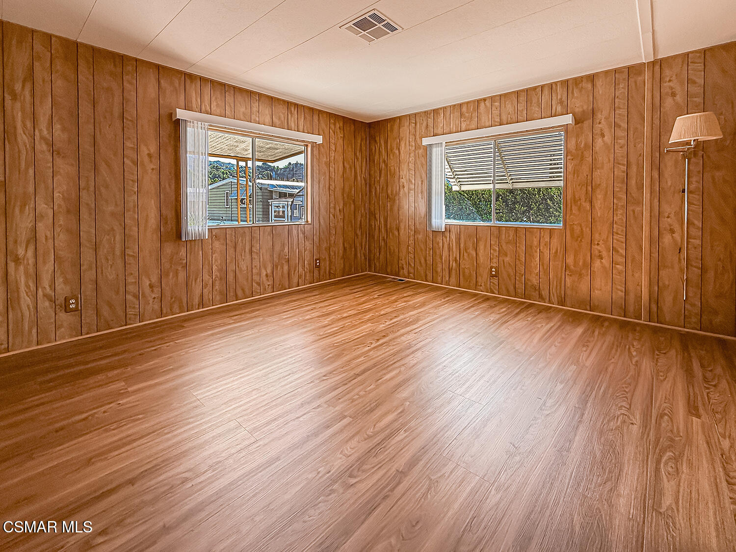 6480 Katherine Street, Unit 109 Simi Valley, CA 93063 - Photo 15 of 29 an empty room with wooden floor and windows
