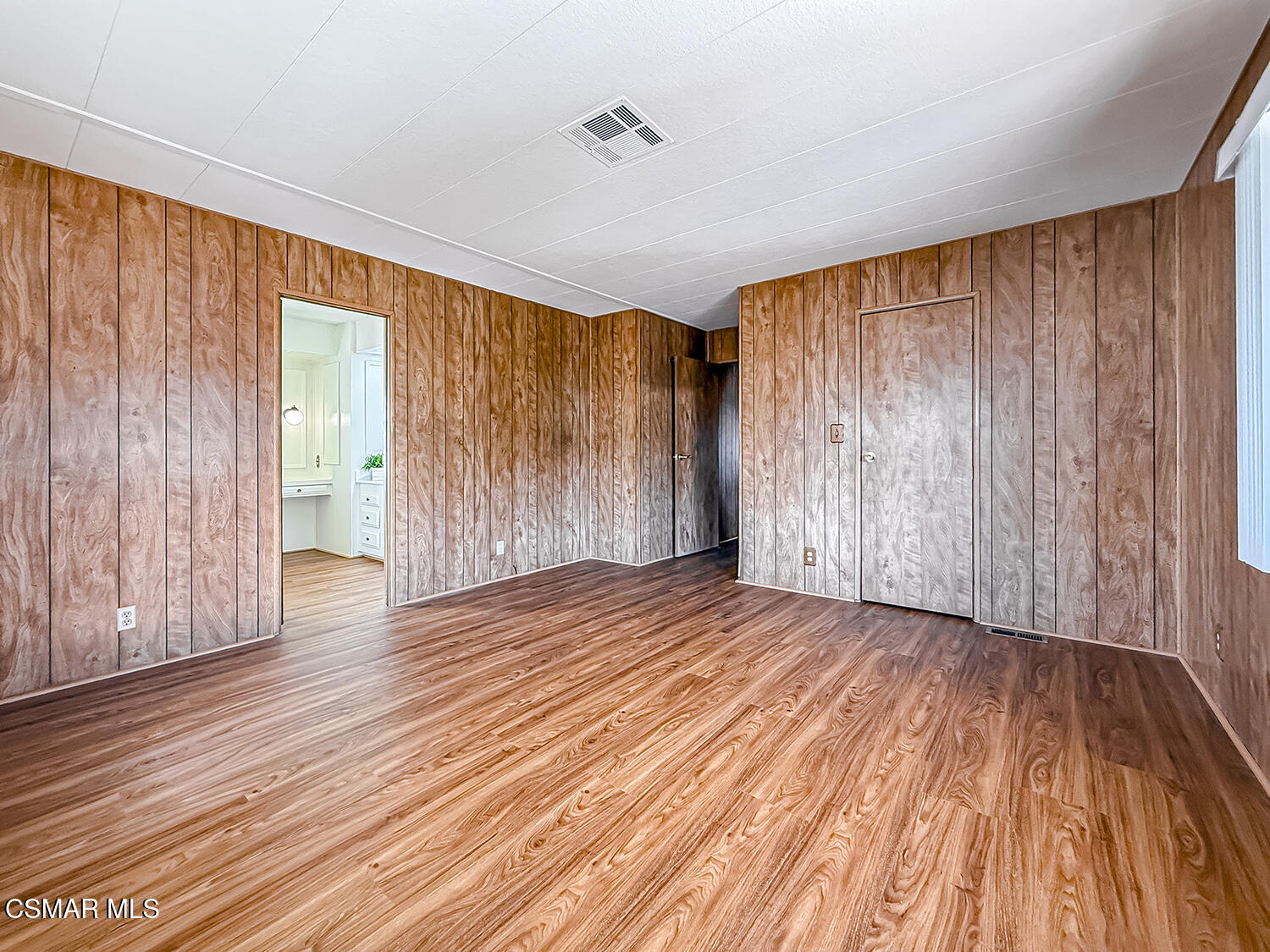 6480 Katherine Street, Unit 109 Simi Valley, CA 93063 - Photo 16 of 29 wooden floor in an empty room with a window