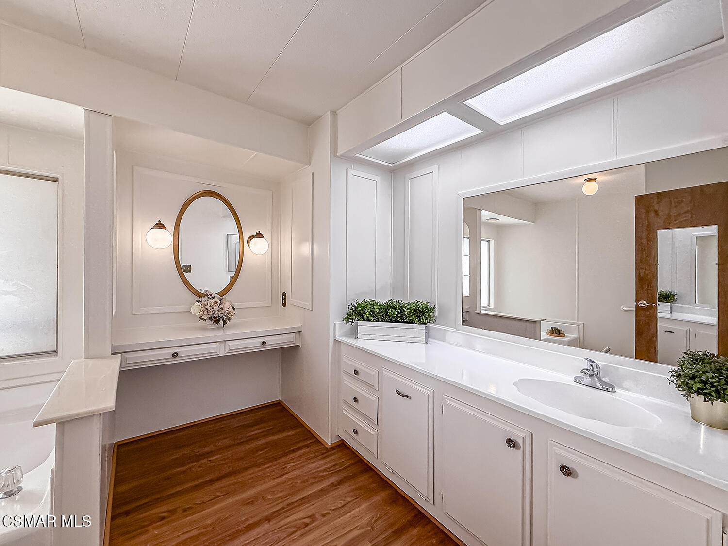 6480 Katherine Street, Unit 109 Simi Valley, CA 93063 - Photo 17 of 29 a bathroom with a double vanity sink and a mirror