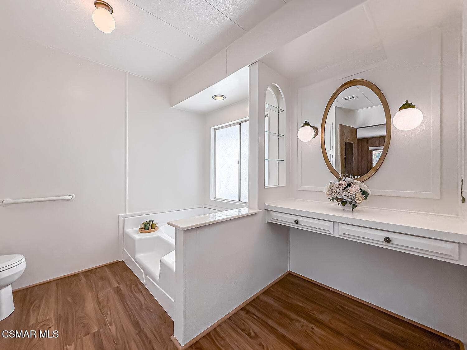 6480 Katherine Street, Unit 109 Simi Valley, CA 93063 - Photo 18 of 29 a view of a hallway with wooden floor and a bathroom sink