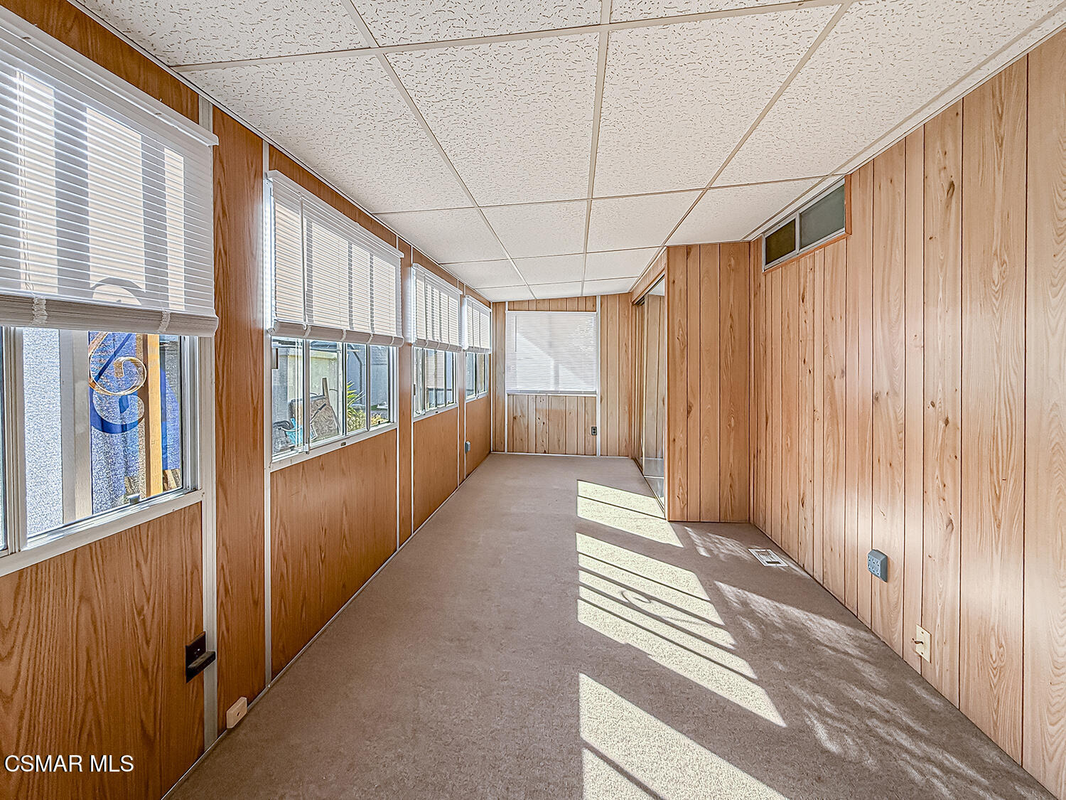 6480 Katherine Street, Unit 109 Simi Valley, CA 93063 - Photo 19 of 29 a view of a hallway with wooden floor and windows