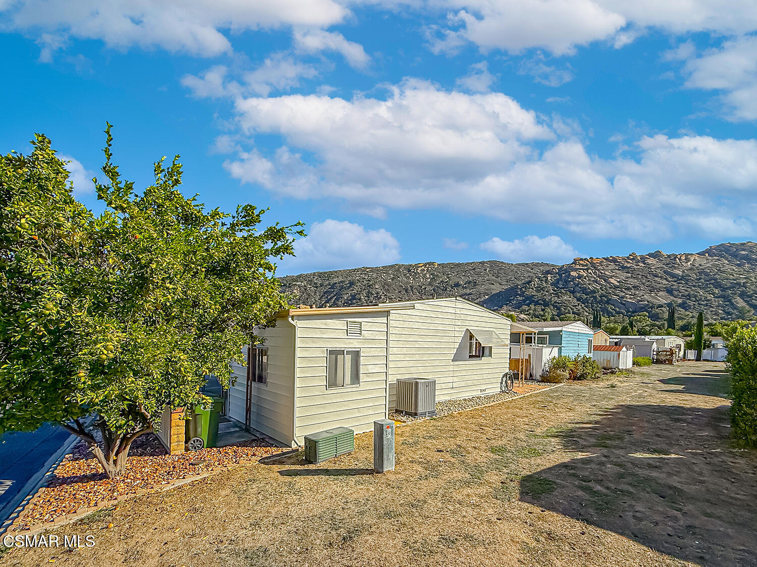 6480 Katherine Street, Unit 109 Simi Valley, CA 93063 - Photo 22 of 29 a view of a white house with a yard