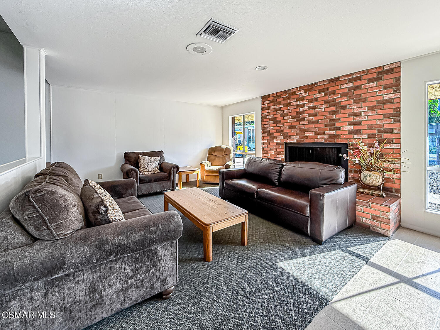 6480 Katherine Street, Unit 109 Simi Valley, CA 93063 - Photo 27 of 29 a living room with furniture and a fireplace