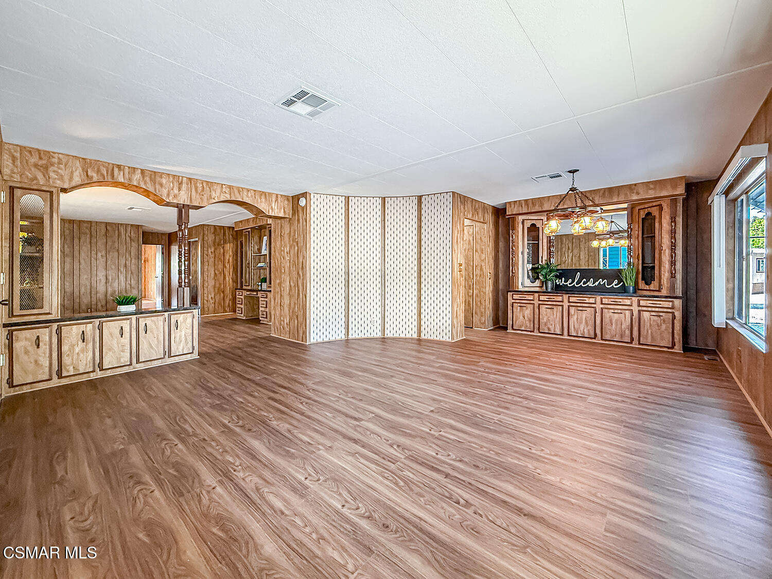 6480 Katherine Street, Unit 109 Simi Valley, CA 93063 - Photo 5 of 29 wooden floor in an empty room with a window