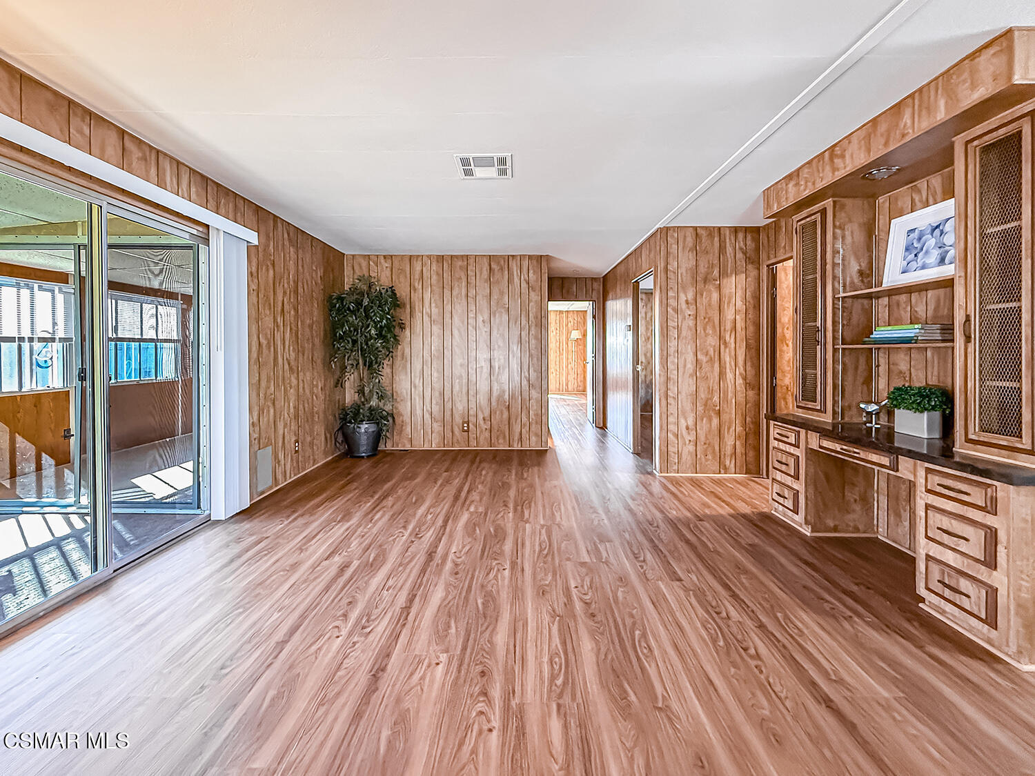 6480 Katherine Street, Unit 109 Simi Valley, CA 93063 - Photo 7 of 29 an empty room with wooden floor and windows