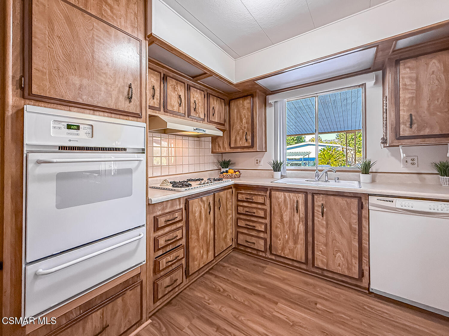 6480 Katherine Street, Unit 109 Simi Valley, CA 93063 - Photo 10 of 29 a kitchen with appliances cabinets and a sink