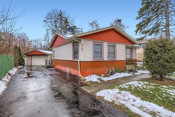 a view of a house with a yard covered in snow
