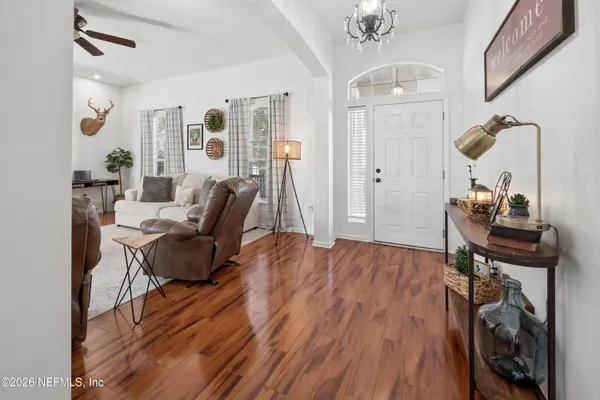 a living room with furniture and a wooden floor