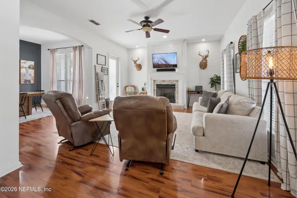 a living room with furniture a fireplace and a flat screen tv