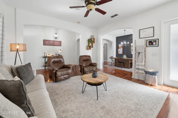 a living room with furniture and a wooden floor