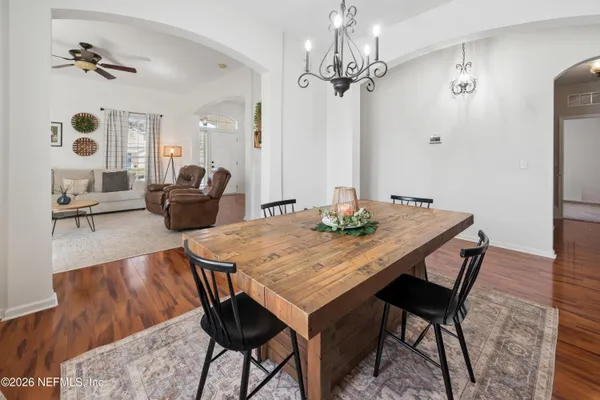 a view of a dining room with furniture and chandelier