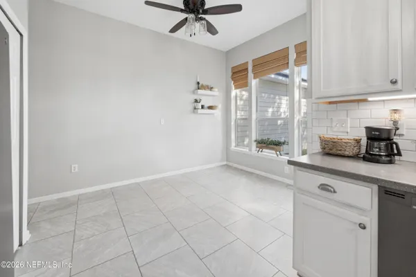 a kitchen with stainless steel appliances white cabinets white stove a refrigerator and a microwave